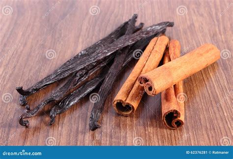 Fragrant Vanilla And Cinnamon Sticks On Wooden Surface Plank Stock