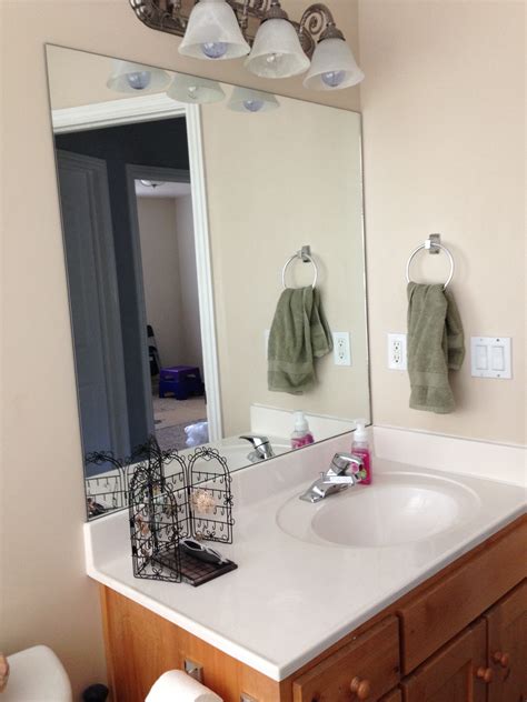 Diy bathroom mirror frame with molding the happier homemaker. DIY Stick-On Mirror Frame - Sawdust Sisters