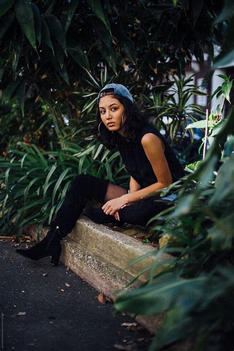 burmese girl sits near plants by stocksy contributor jayme burrows stocksy