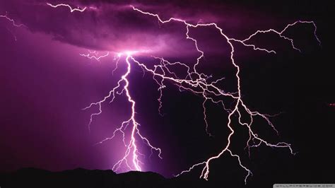 Download Powerful Purple Lightning Illuminates The Night Sky Wallpaper
