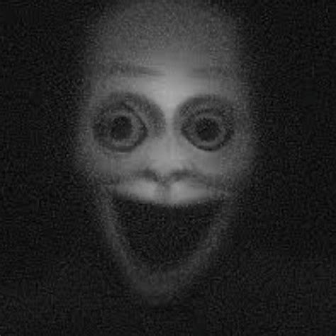 A Creepy Face With Big Eyes In The Dark