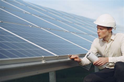 Solar Technician Inspecting Solar Panels · Free Stock Photo