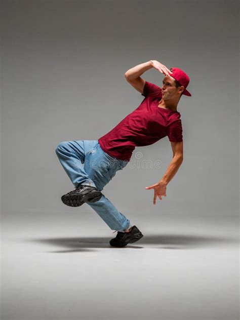 Guy Dancing Contemporary Dance In Studio Neon Light Grey Background