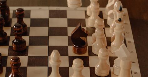 Person Playing Chess Game On Chess Board · Free Stock Photo