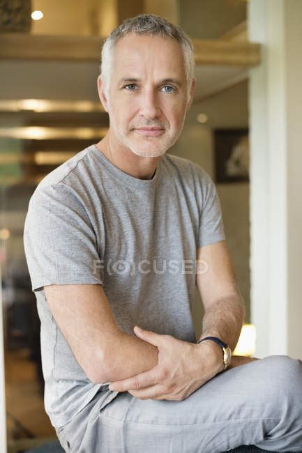 Portrait Of Confident Grey Haired Mature Man Sitting At Home — Clothes