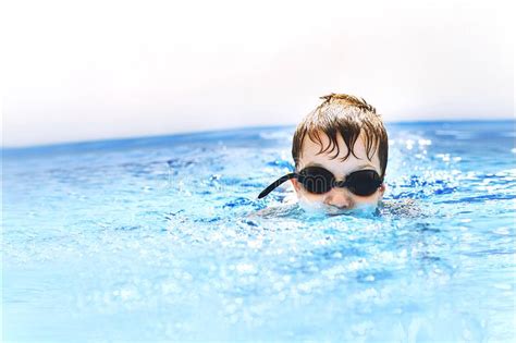 Boy Dives In Swimming Pool With Swimming Glasses Boy Swims In The Pool