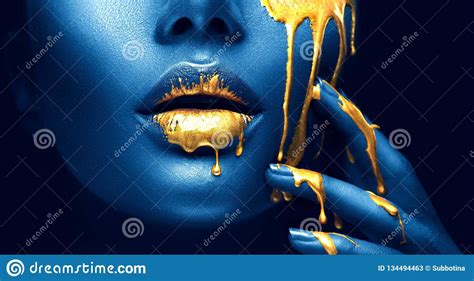 Golden Paint Smudges Drips From The Face Lips And Hand Golden Liquid Drops On Beautiful Model