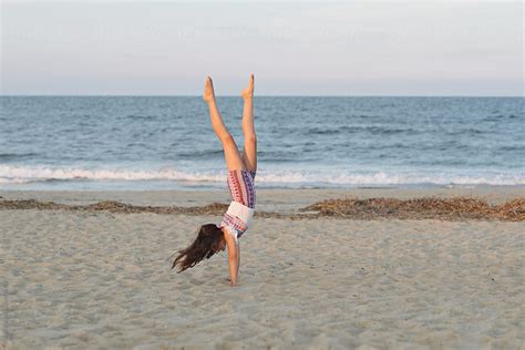 Young Girl Doing Handstand On The Beach Stocksy United