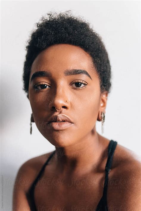 Portraits Of A Beautiful Young Black Woman Against A White Wall By