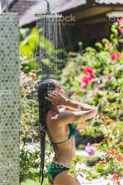 Woman Taking Shower Outside In Tropical Green Bali Garden With A Lot