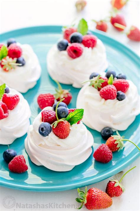 Pile high with lemon curd, whipped cream, and fresh fruit to make a naturally delicious gluten free dessert! Pavlova Recipe (VIDEO) - NatashasKitchen.com in 2020 ...