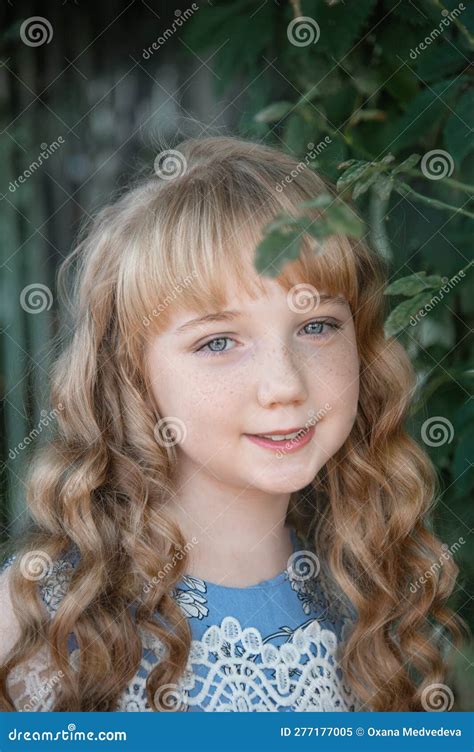 Portrait Of A Girl With Long Blonde Hair On The Street A 9 11 Year Old
