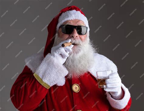 Premium Photo Santa Claus Wearing Sunglasses Smoking A Cigar And