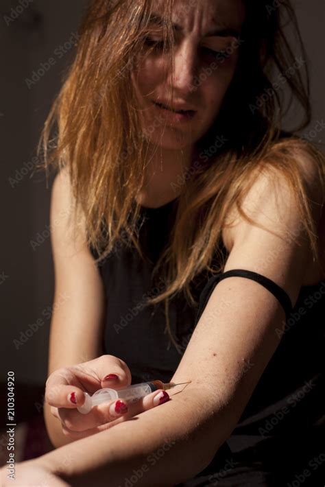 Drug Addicted Girl With A Syringe Using Drugs Stock Photo Adobe Stock
