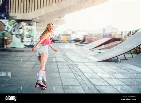 Blonde Girl Is Rollerblading She Is Looking Back On Camera Her Face Is Particulary Covered