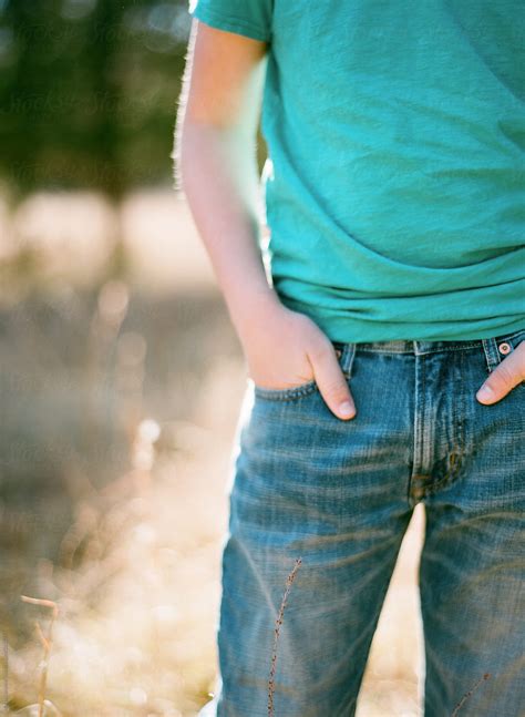 Close Up Of Boy Wearing Jeans And Hands In Pockets by Marta Locklear