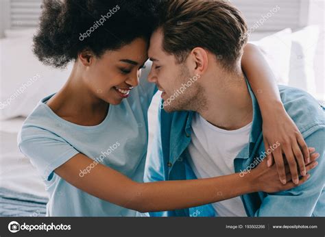 Young Woman Embracing Boyfriend While Sitting Bed — Stock Photo
