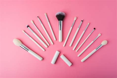 Premium Photo White Makeup Brushes On A Pink Background
