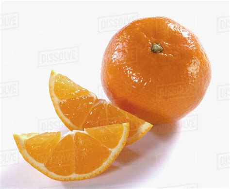 One Orange And Two Orange Wedges Stock Photo Dissolve