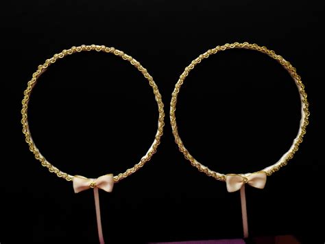 two large gold hoop earrings with bows on each side and a purple box in
