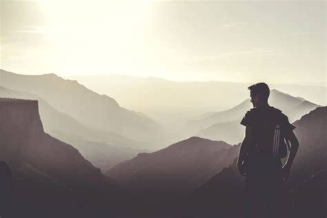 Hd Wallpaper Man Standing On Rocks Near Mountains Pointing Sky During