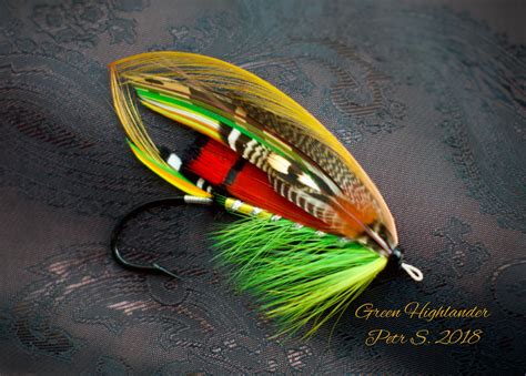 An Orange And Green Fishing Lure On A Black Background