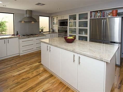 The inviting designing concept and functional features with effective work triangle makes your cooking easy. Modern l-shaped kitchen design using floorboards - Kitchen ...