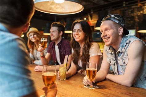 Happy Friends With Drinks Talking At Bar Or Pub Stock Image Image Of Gathering Beer 55296029