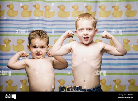 Two Boys Flexing Muscles In Bathroom Stock Photo Alamy