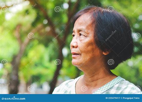 asian elderly woman standing in the garden feel happy stock image image of mature elderly