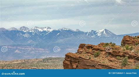 Cliff With Snow Capped La Sal Mountain In Moab Ut Stock Photo Image