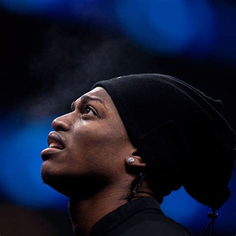 A Close Up Of A Person Wearing A Beanie And Looking Up At The Sky