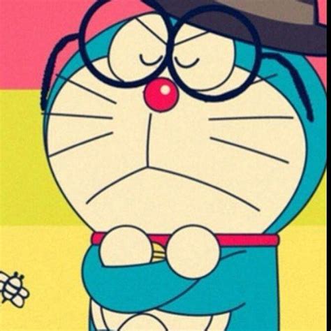 A Cartoon Character With Glasses And A Hat On Sitting In Front Of A
