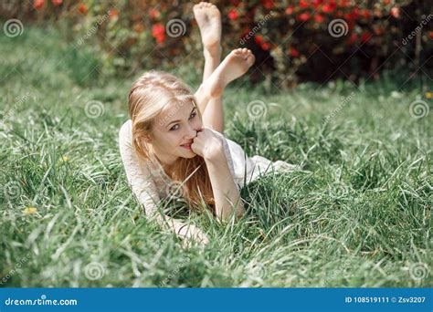 Outdoor Portrait Of Beautiful Blonde Girl Lying On Green Grass Stock Image Image Of Beauty