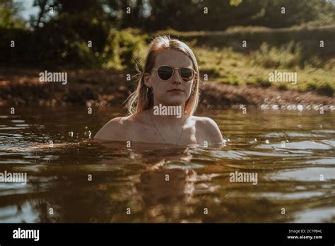 Beautiful Woman Skinny Dipping And Wild Swimming In River Stock Photo