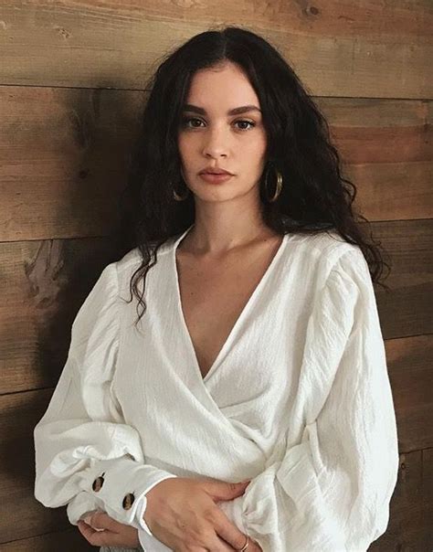 An Instagram Photo Of A Woman With Long Dark Hair And Wearing A White Top