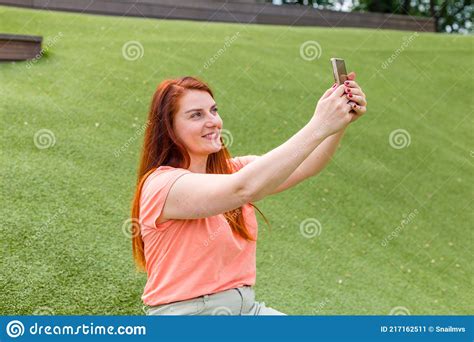 Outdoor Portrait Of Beautiful Ginger Girl Taking A Selfie Happy Young Woman Using Smart Phone