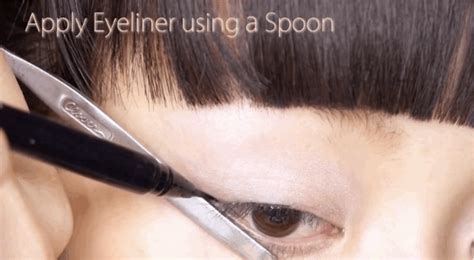 This content is imported from youtube. Applying eyeliner - Step 1: Create the perfect wing tip using the straight edge of the spoon ...