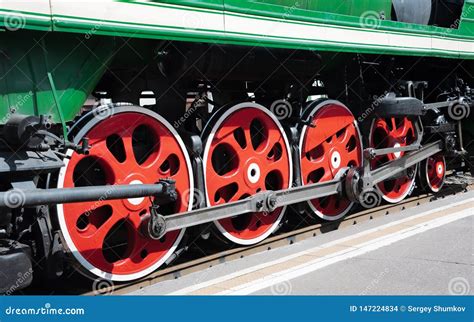 Closeup Of Four Big Red Driving Wheels Of A Steam Locomotive Stock