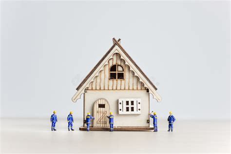 Figurines Of Builders Working On The House Developing Concept Stock