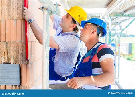 Construction Workers On Site Checking Quality Stock Images Image