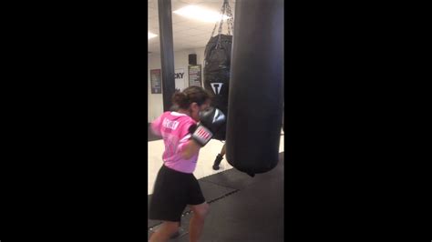 my sister in boxing and my brother in the back showing her how to punch the punching bag