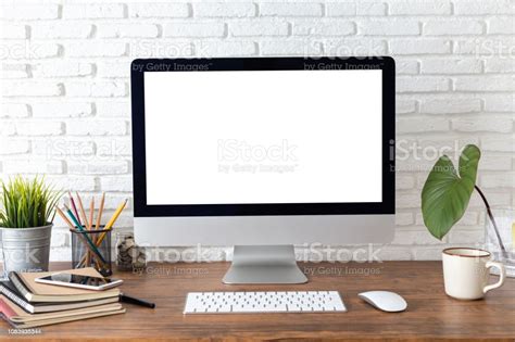 Workspace With Computer With Blank White Screen And Office Supplies On