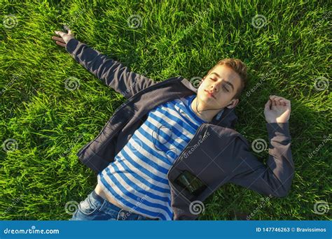 Teenage Boy Lying On Grass With Phone Stock Image Image Of Lying