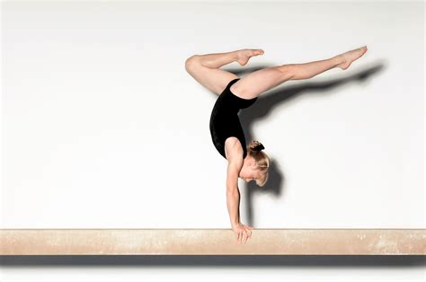 Young Gymnast Doing Handstand On Balance Beam Flair
