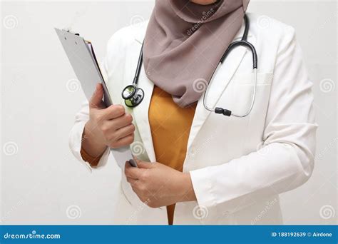 Asian Muslim Female Doctor Wearing Hijab With Stethoscope In White Coat