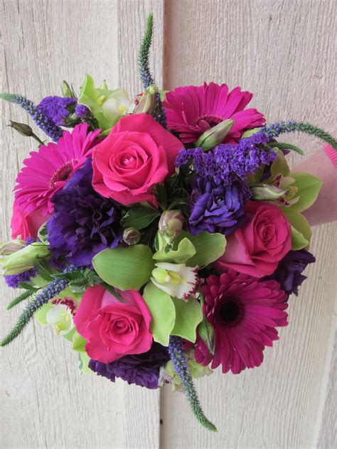The bride wanted to embrace the seasonal colours and loves gerberas, so we combined the two. Magenta roses and gerbera daisies dominate this stunning ...