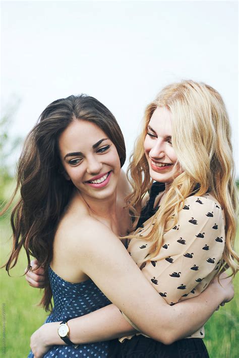 Two Female Friends Hugging And Laughing Outdoors By Stocksy Contributor Jovana Rikalo Stocksy