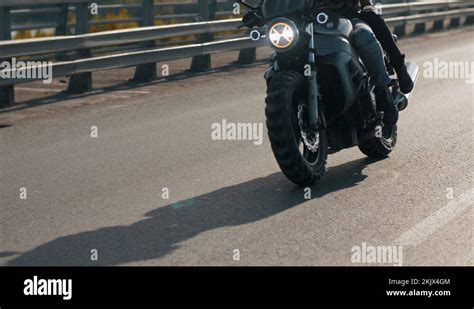 Close Up Front View Of Young Bikers On Riding Motorcycle In Urban