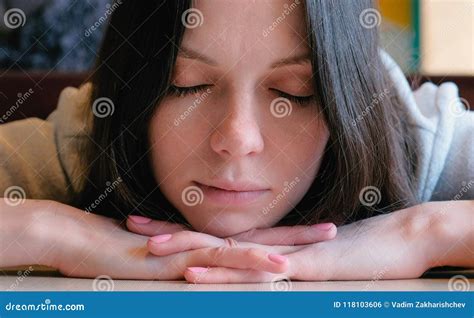 Sleepy Woman With Closed Eyes Sitting In A Cafe And Waiting Her Order